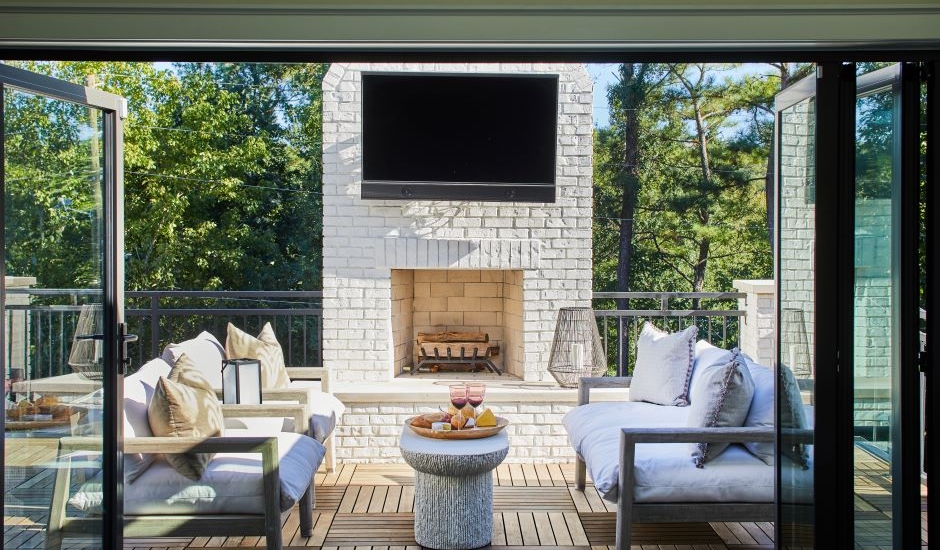 Ipe deck with sliding panel doors and fireplace with television
